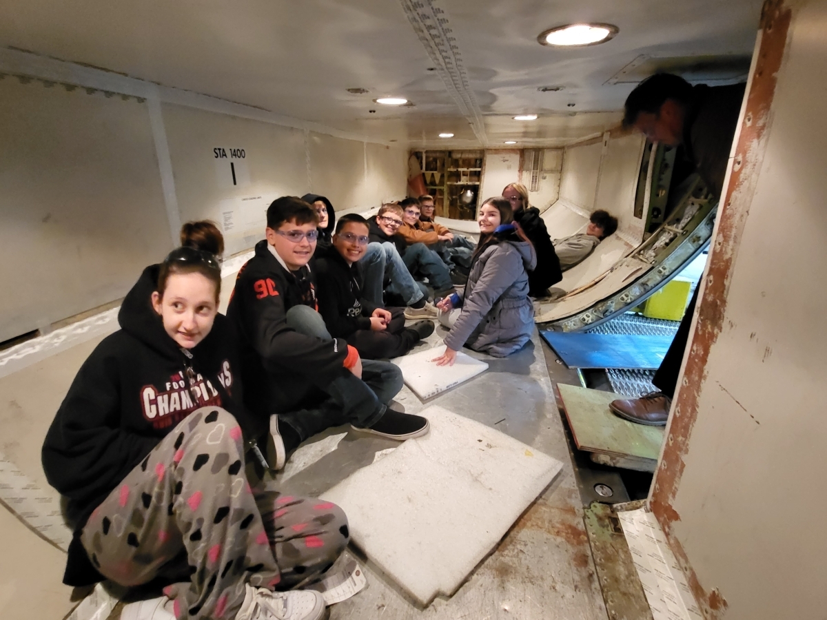 students sitting inside of plane