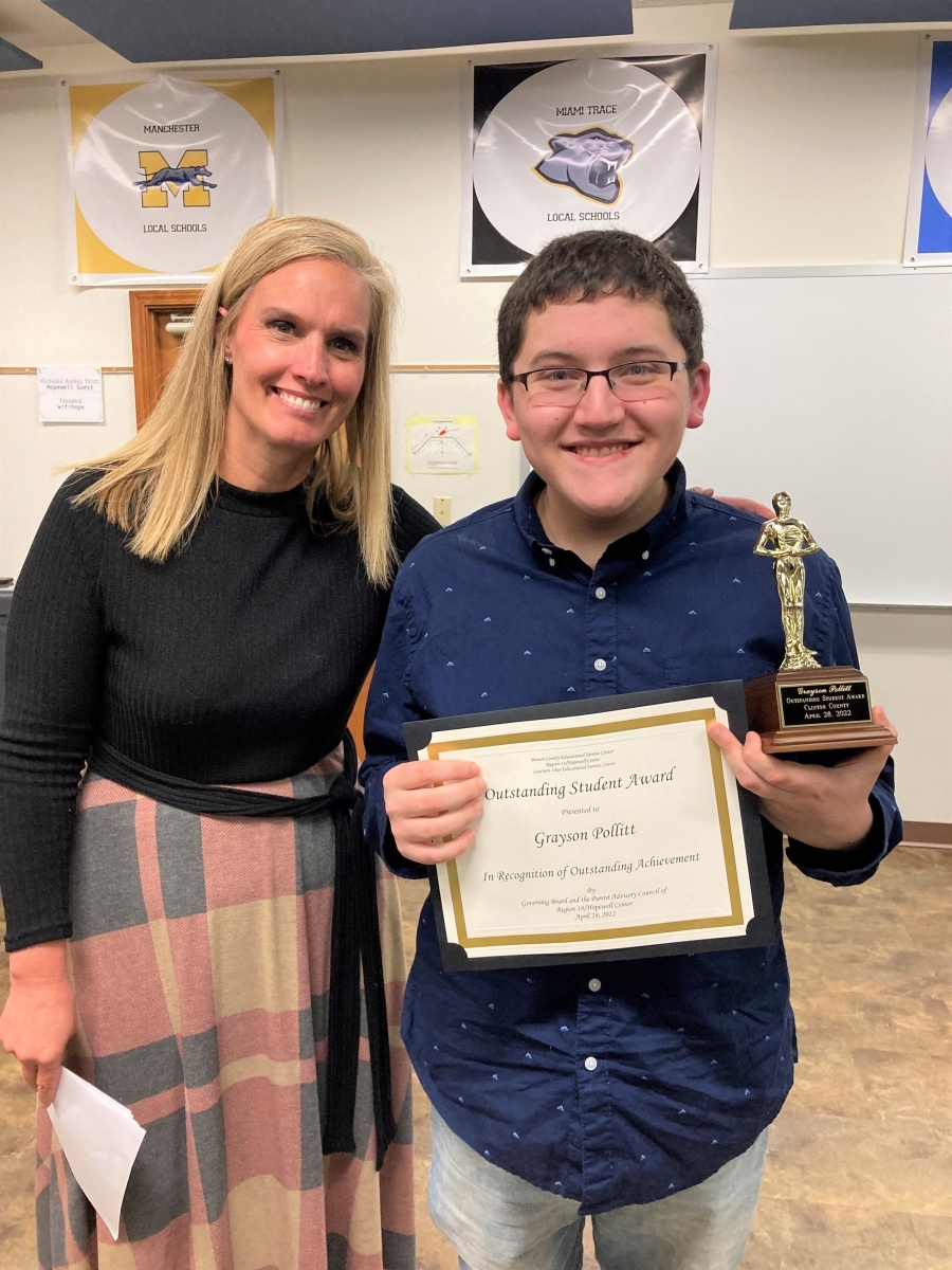 teacher with student holding award